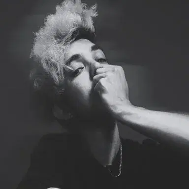 DJ A$H in a black-and-white portrait